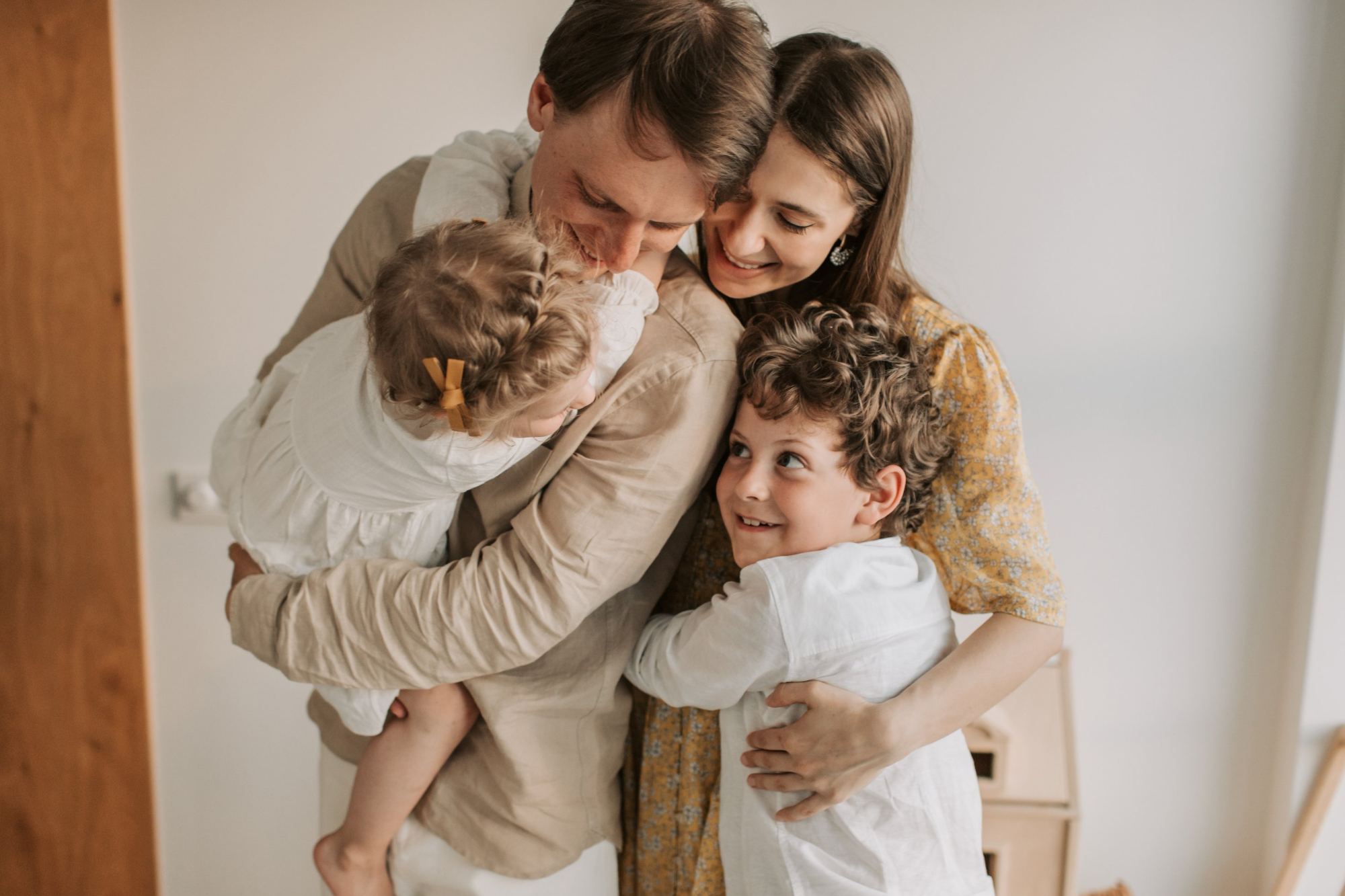 Family of Four Happily Hugging Each Other | Xray & MRI Specialist Near Me | Fowler Simmons Radiology